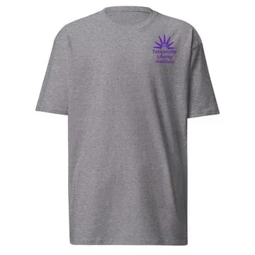Heather grey heavyweight t-shirt with a small purple Tocqueville Liberty Institute sunburst emblem on the chest