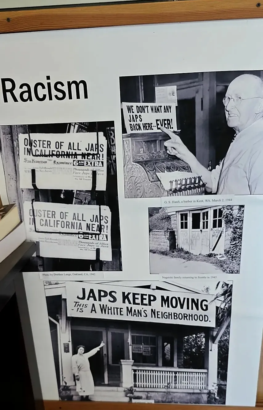 Exhibit panel: a Kent, Washington barber and his sign, March 2, 1944; Hearst newspaper racks photographed by Dorothea Lange in Oakland, 1942; graffiti on the Nagaishi family garage, Seattle, 1945; and a Seattle porch banner.