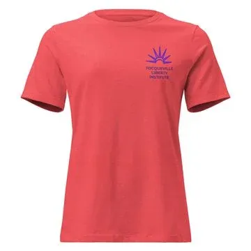 Coral women’s t-shirt with a small purple Tocqueville Liberty Institute sunburst emblem on the chest